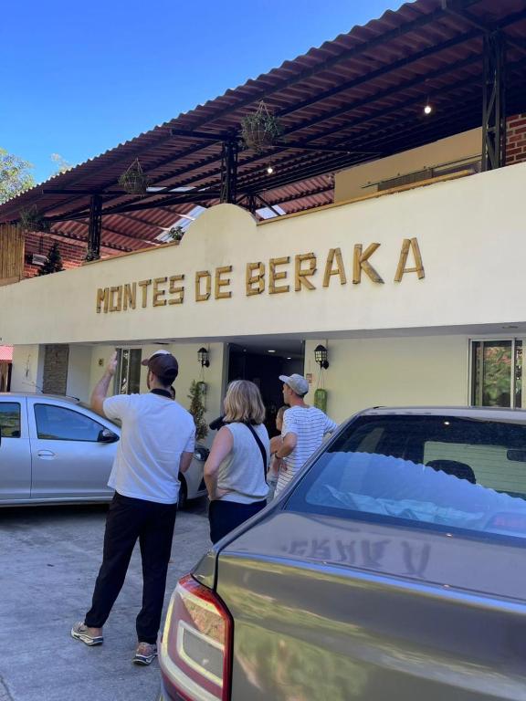 a group of people standing outside of a car dealership at Montes De Beraka in Minca