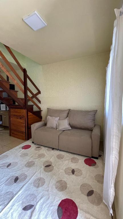 a living room with a couch and a staircase at Apto 013 - Residencial Canaã in Porto Velho