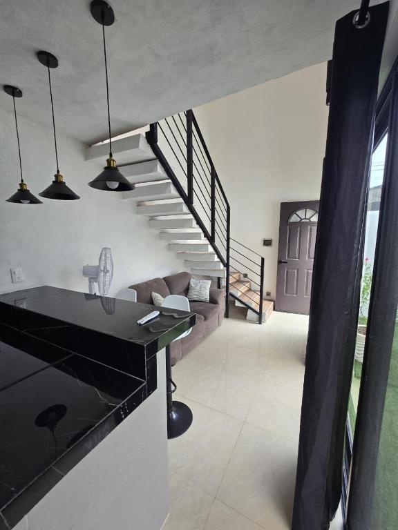 a living room with a staircase in a house at Serenity Elegance Suite PB in Mérida
