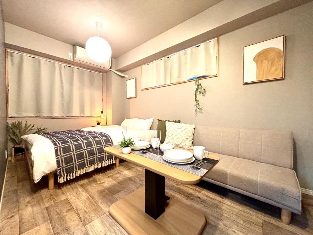 a living room with a couch and a table at Hal Kokubunji in Kokubunji