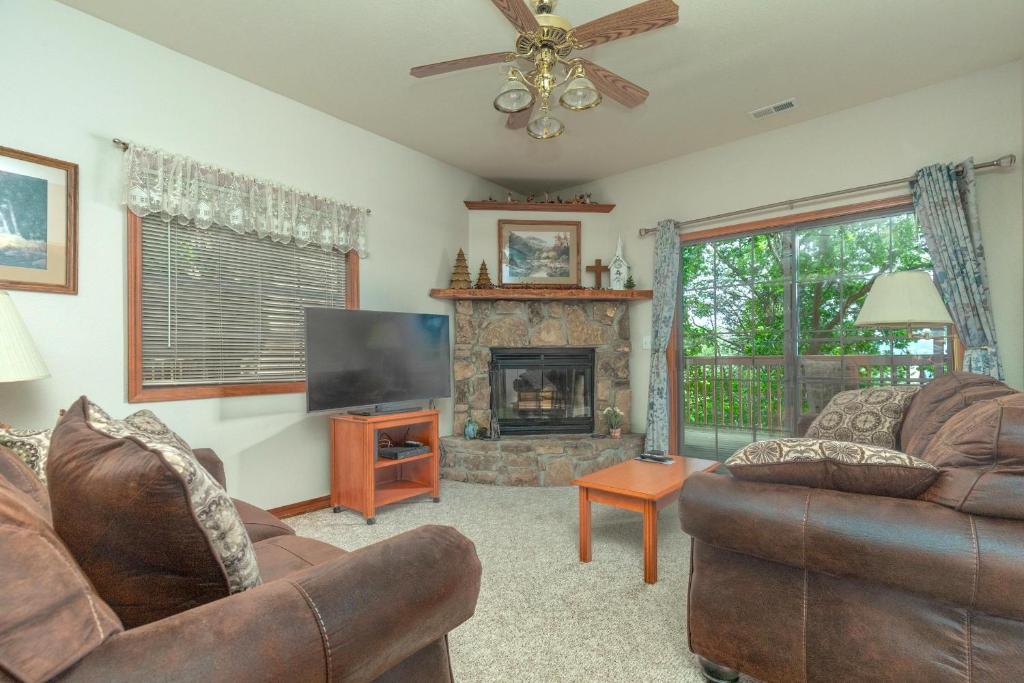 a living room with two couches and a fireplace at 1BR Village At Indian Point 601 near SDC-Free Tickets Daily up to $500 in Branson