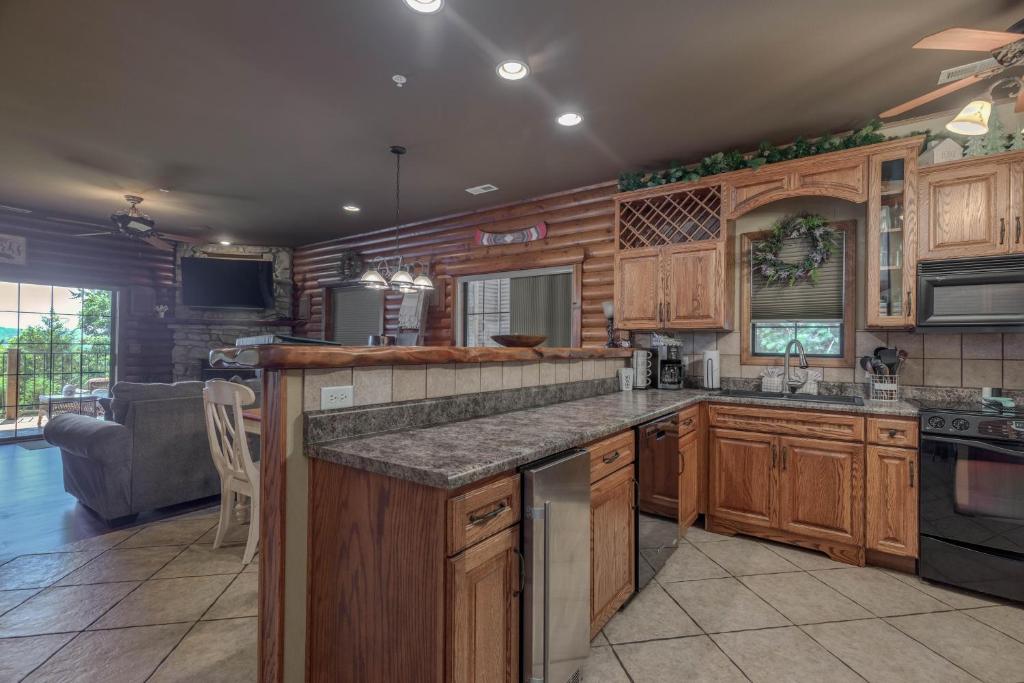 a kitchen with wooden cabinets and a counter top at 1BR Village At Indian Point 2102 near SDC-Free Tickets Daily up to $500 in Branson