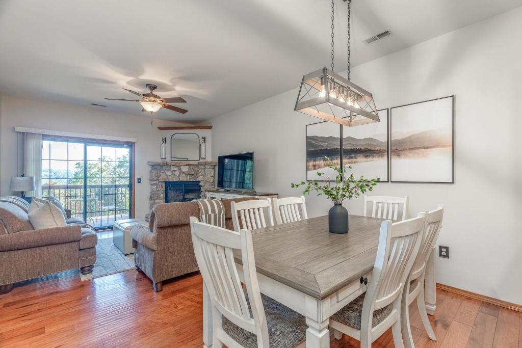 a dining room and living room with a table and chairs at 2BR Village At Indian Point 1202 near SDC-Free Tickets Daily up to $500 in Branson