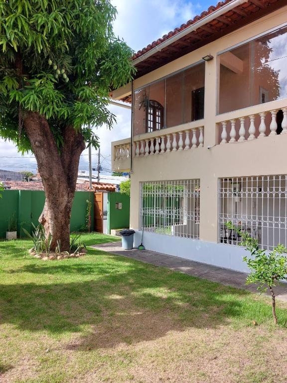 a house with a tree in front of it at Casa Meão in Recife
