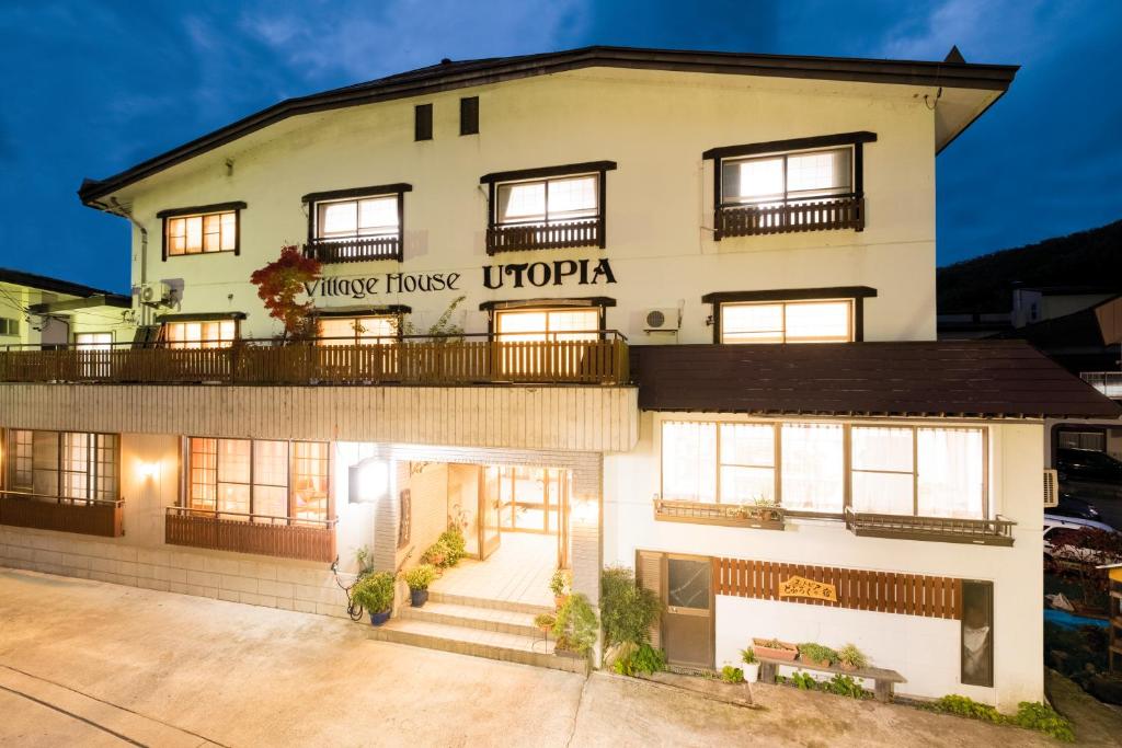 a building with a sign that reads utopia at Nozawa Onsen Utopia in Nozawa Onsen