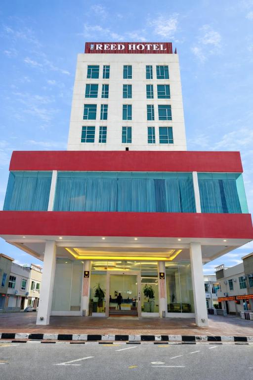 a hotel with a red and white building at THE REED HOTEL Melaka in Malacca
