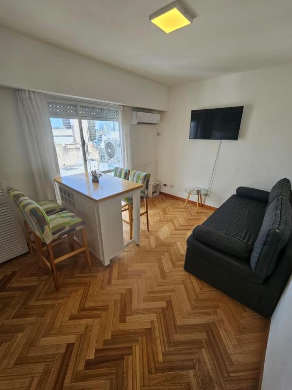 a living room with a couch and a table and a desk at Aire Porteño in La Porteña
