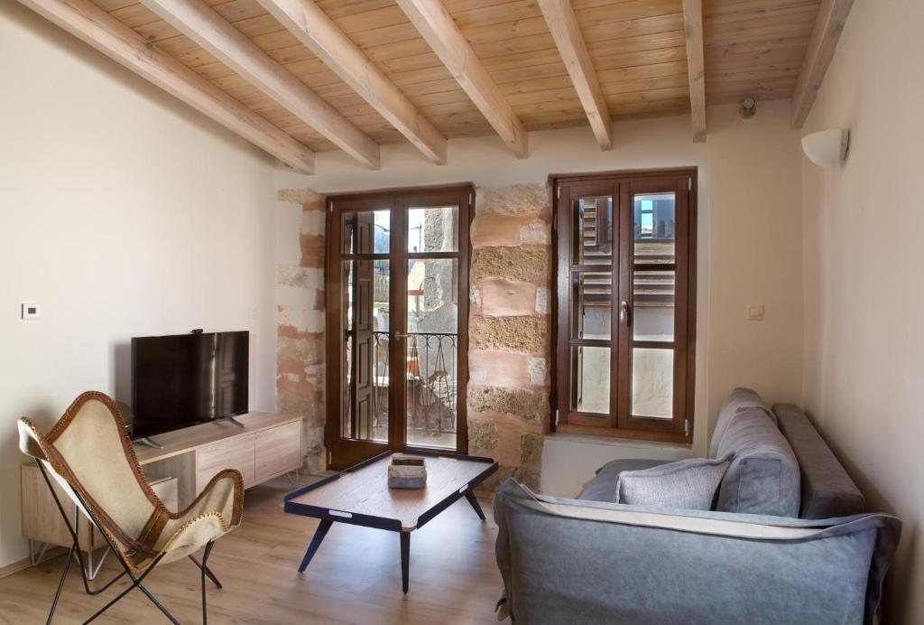 a living room with a couch and a tv at C&M Residence Chania Old Town in Chania