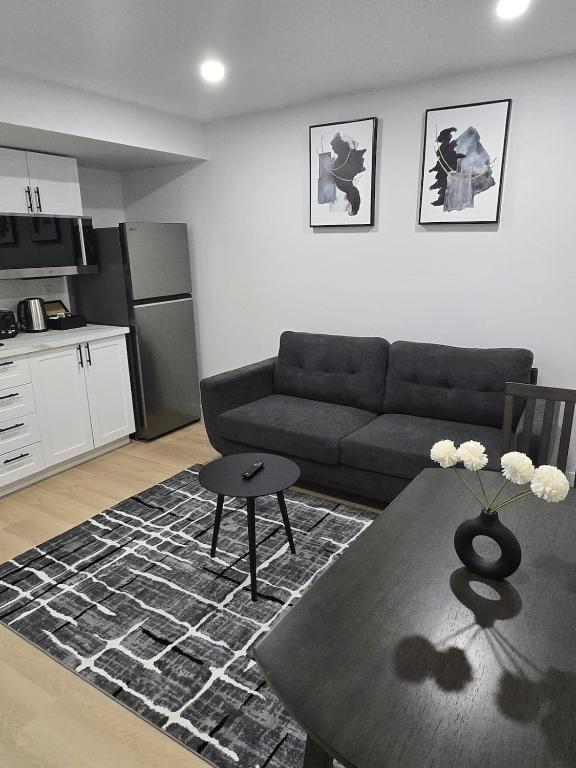 a living room with a couch and a table at Cozy 1-Bedroom Private Basement Suite in Winnipeg with separate entrance in Winnipeg