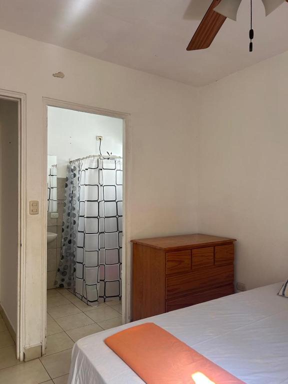 a bedroom with a bed and a dresser and a mirror at Casa amueblada in Jinotepe