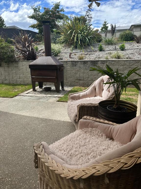 two wicker baskets sitting on the side of a patio at The Garden Room in Clyde