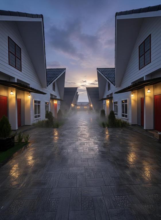 an empty driveway between two houses at night at D'Anjung Cottage Paka in Paka