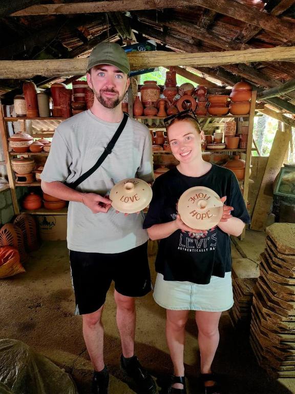 a man and a woman holding two frisbees at Tiny Villa Homestay - ONLY FOR FOREIGN BOOKINGS in Kurunegala