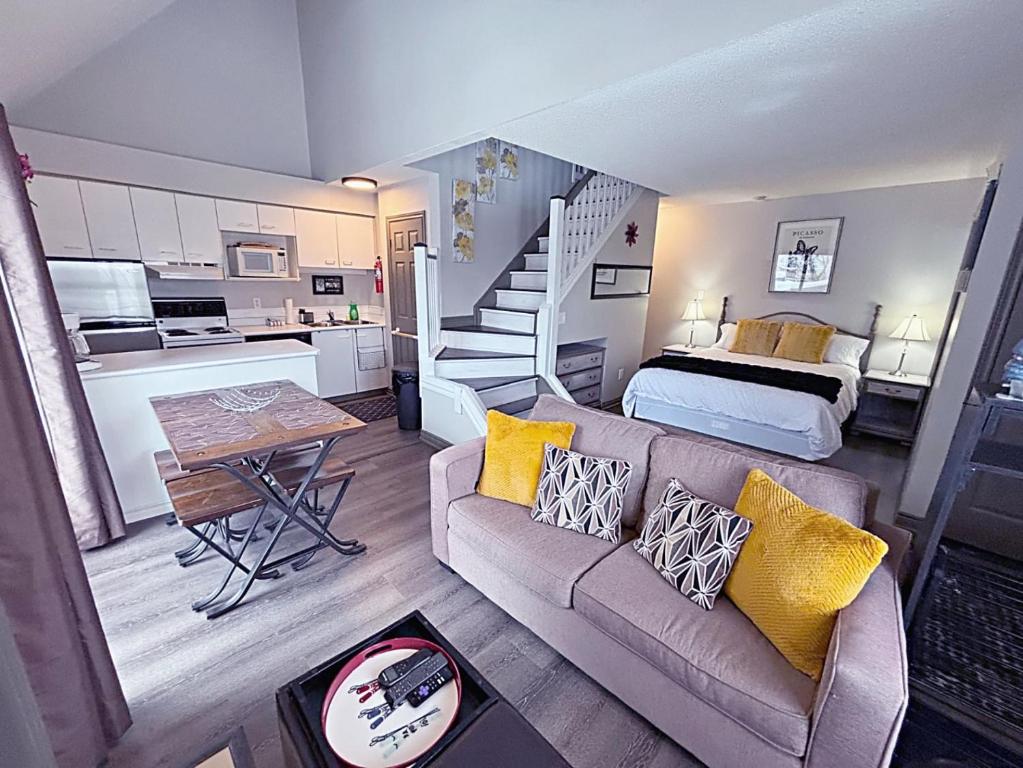 a living room with a couch and a bed at Slopeside Loft at North Creek Resort in Blue Mountains