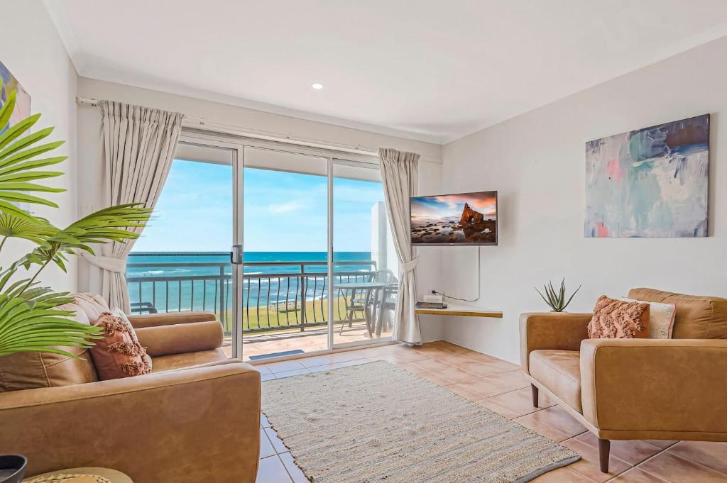 a living room with a view of the ocean at 10T Beachfront Apartments in Lennox Head