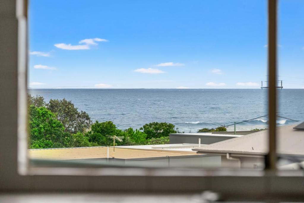 a view of the ocean from a window at Shelly Vista in East Ballina