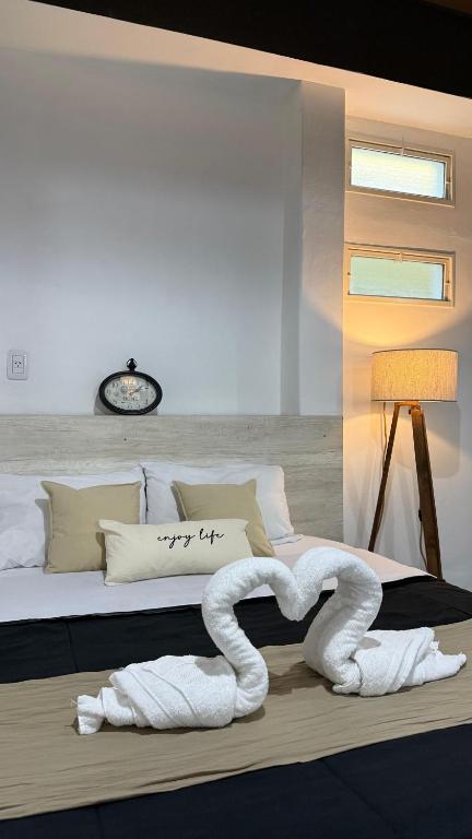 a bedroom with a bed with a swan on it at EzeApart in Ezeiza