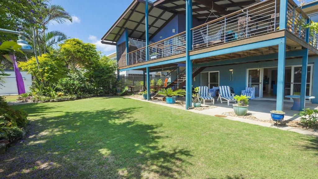 a yard in front of a house with a balcony at Moana Retreat in Lennox Head