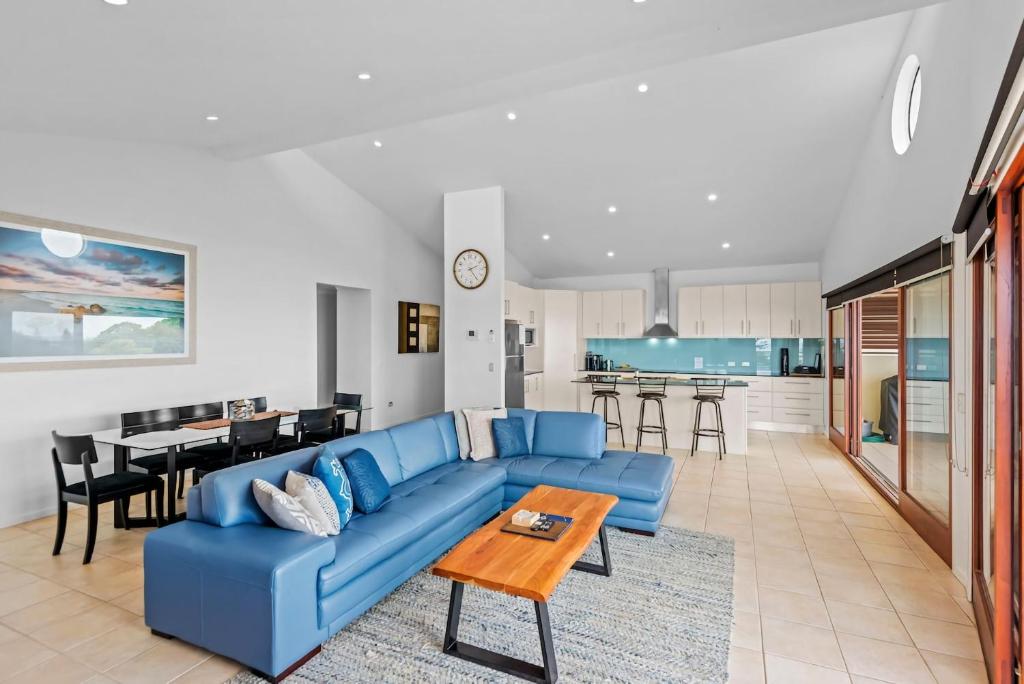 a living room with a blue couch and a table at Oceanic 3 in East Ballina