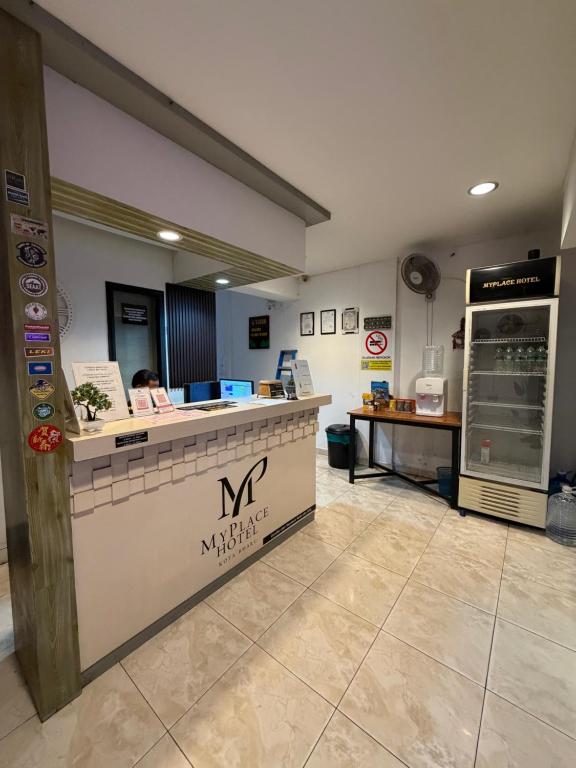a restaurant with a counter in a room at MyPlace Sri Cemerlang Kota Bharu in Kota Bharu