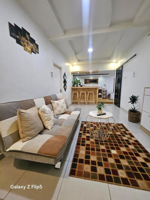 a living room with a couch and a checkered floor at Erigeron homestay dieng in Banjarnegara