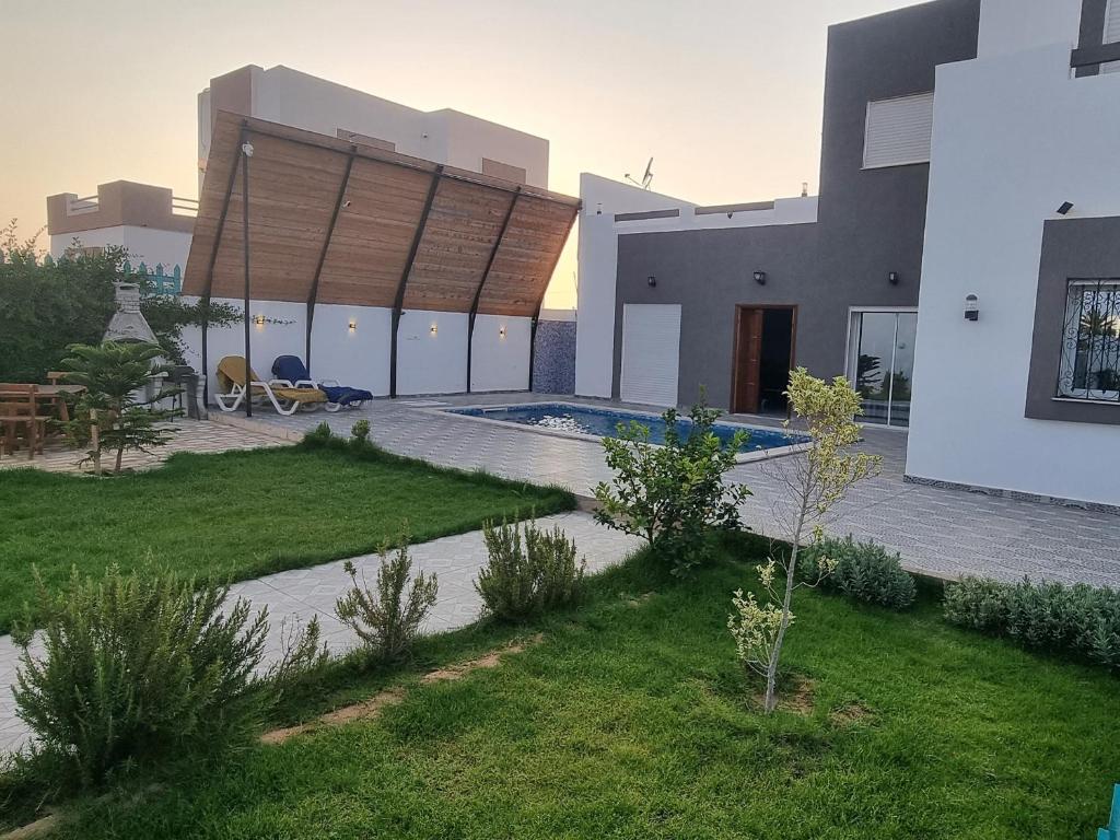 a view of a house with a swimming pool at Dar fadloun in Midoun