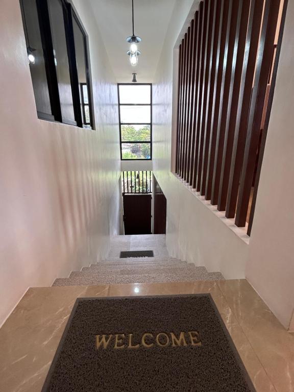 a welcome mat in the hallway of a house at Yalyn's Hometel Kabankalan in Kabankalan