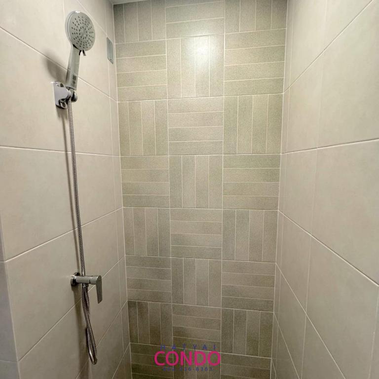 a shower with a shower head in a bathroom at dcondo sand hatyai Garden View 1 month only in Hat Yai