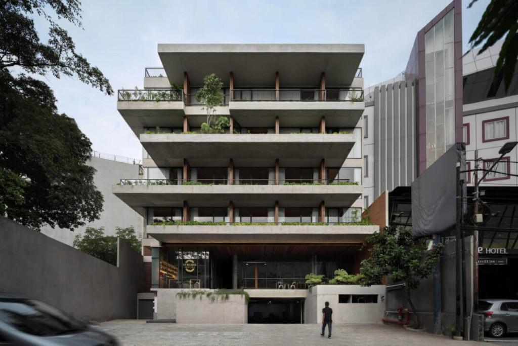 a man standing in front of a building at Nagomi Suites & Hotel in Jakarta