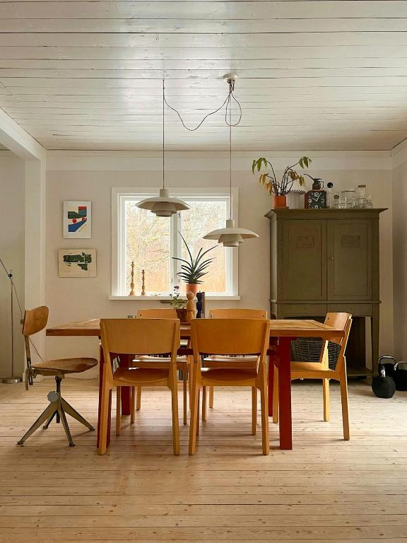 a dining room with a table and chairs at Cosy House Surrounded By Nature in Diö