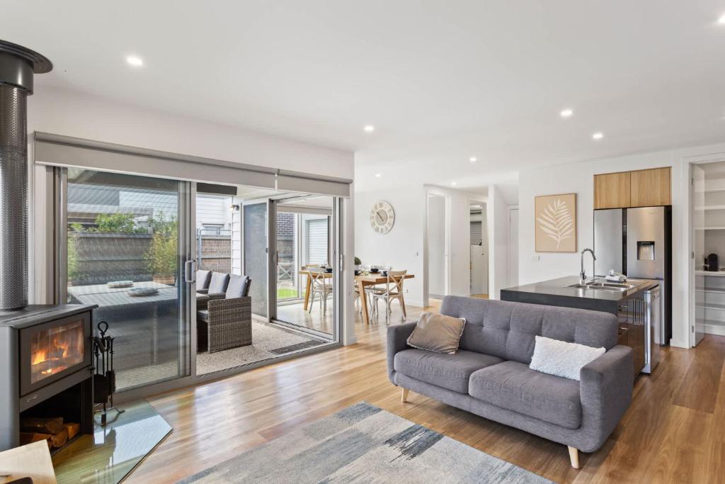 a living room with a couch and a fireplace at Stylish Townhouse Opposite Golfcourse in Cowes
