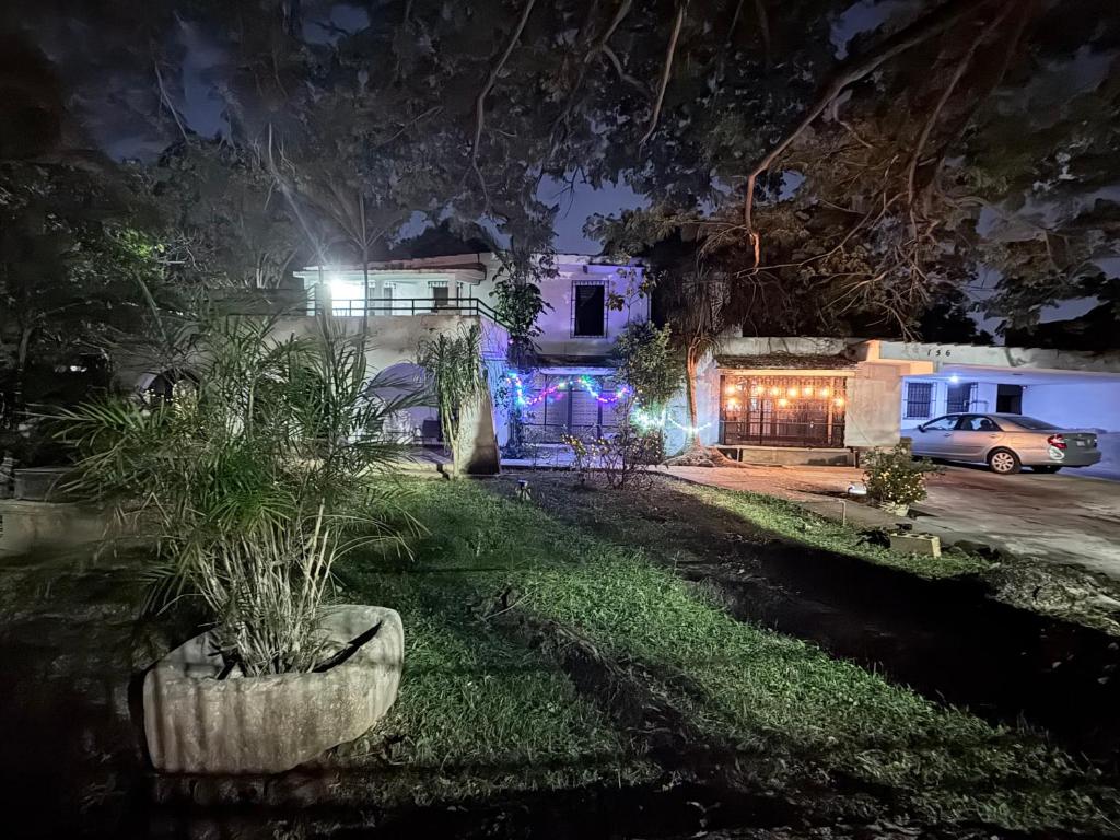 a house with a car parked in front of it at night at Casa Buenavista in Mérida