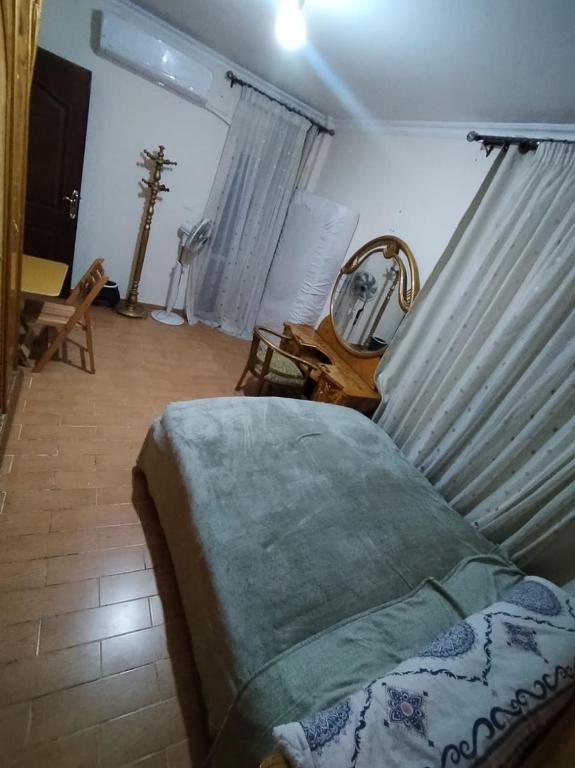 a bedroom with a bed and a mirror at Pink Horizon Homestay - for Men ONLY in Dumyāţ al Jadīdah