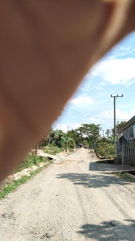a view of a dirt road from a vehicle at Kotabaru in Gununganjar