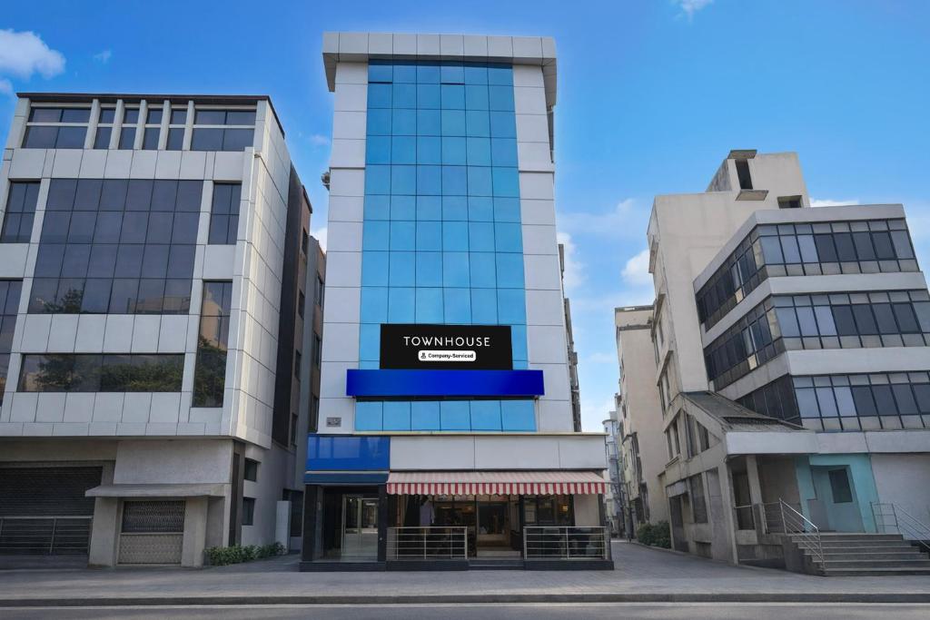 a tall building with a sign that reads powerhouse at Super Townhouse Richmond MG Road Metro Formerly Richmond Residency in Bangalore
