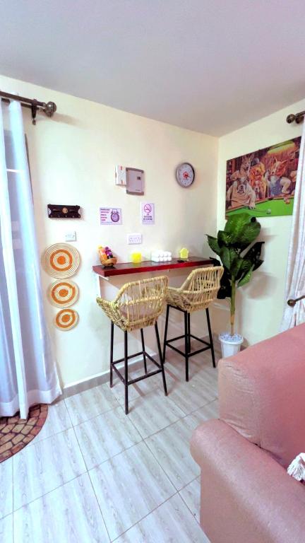 a living room with a table and chairs at Polea Tatu in Ngong