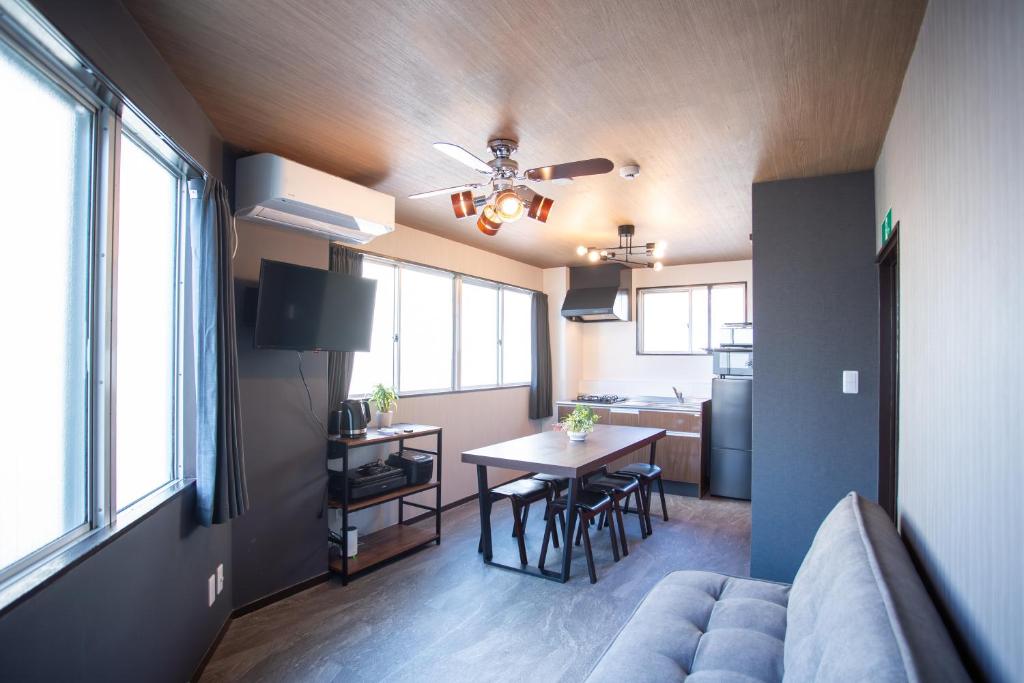 a living room with a couch and a table at H-1ビル 301 hiroshima in Hiroshima