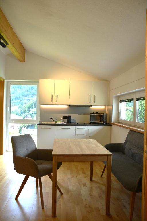 a kitchen and living room with a table and a couch at Ferienwohnung Davenna in Vandans