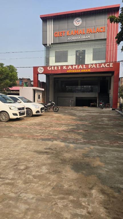 a parking lot with cars parked in front of a garage at GeetKamal Palace Ayodhya Dham in Ayodhya