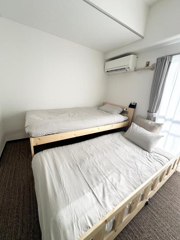 Llit o llits en una habitació de Hanazono405