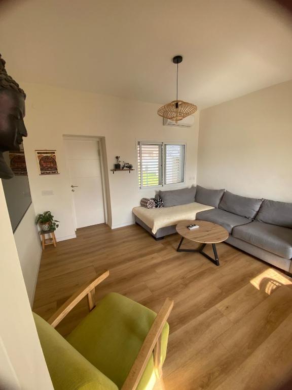 a living room with a couch and a table at Rivers view in kibbutz Dafna in Dafna