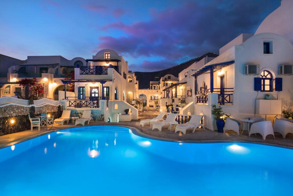 a villa with a swimming pool at night at Samson΄s Village in Perissa