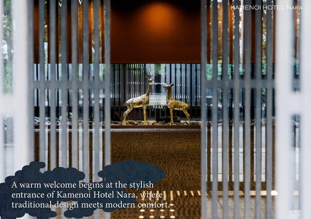 a museum with a statue of a gazelle behind a fence at KAMENOI HOTEL Nara in Nara