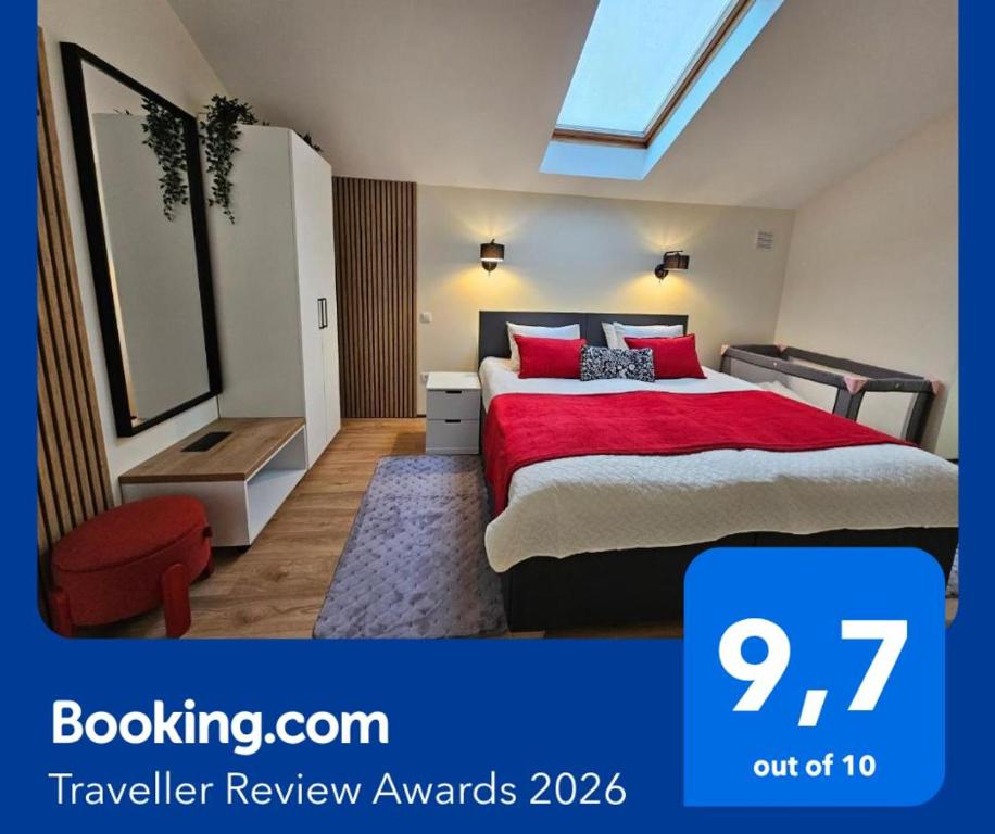 a bedroom with a bed with a red comforter at ApartHotel Ritms in Krāslava