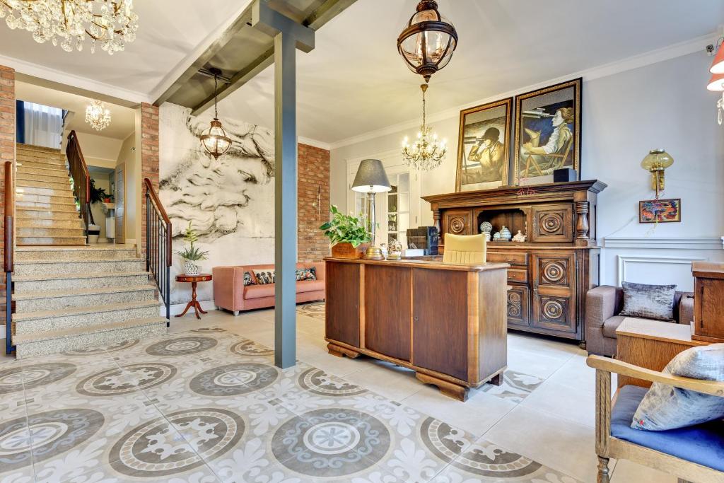 a living room with a desk and a staircase at 730 Art House in Sopot