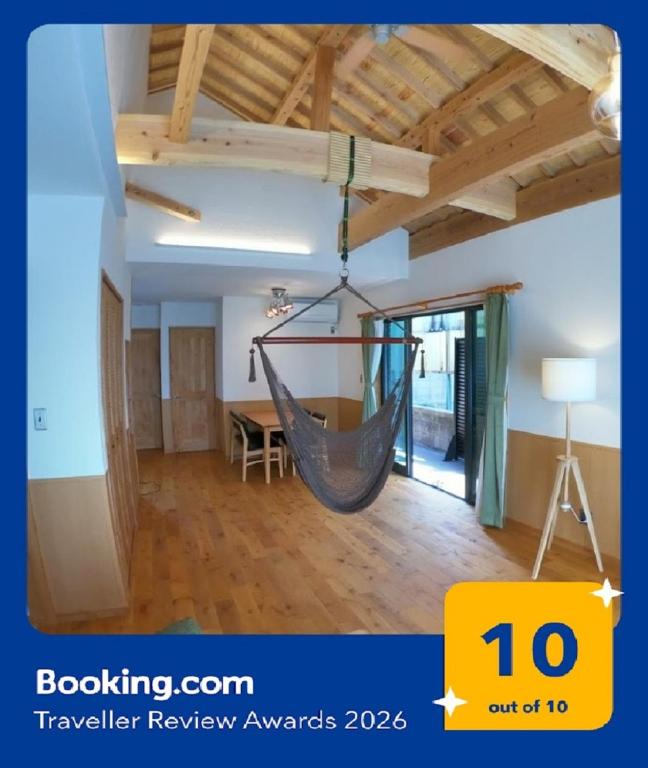 a room with a hammock hanging from the ceiling at CARA-YA(かーらやー） in Ishigaki Island