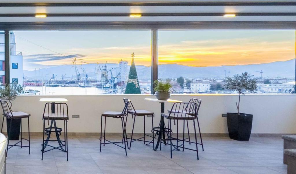 a room with a table and chairs and a large window at Blue Horizon Residence Panoramic View in Volos