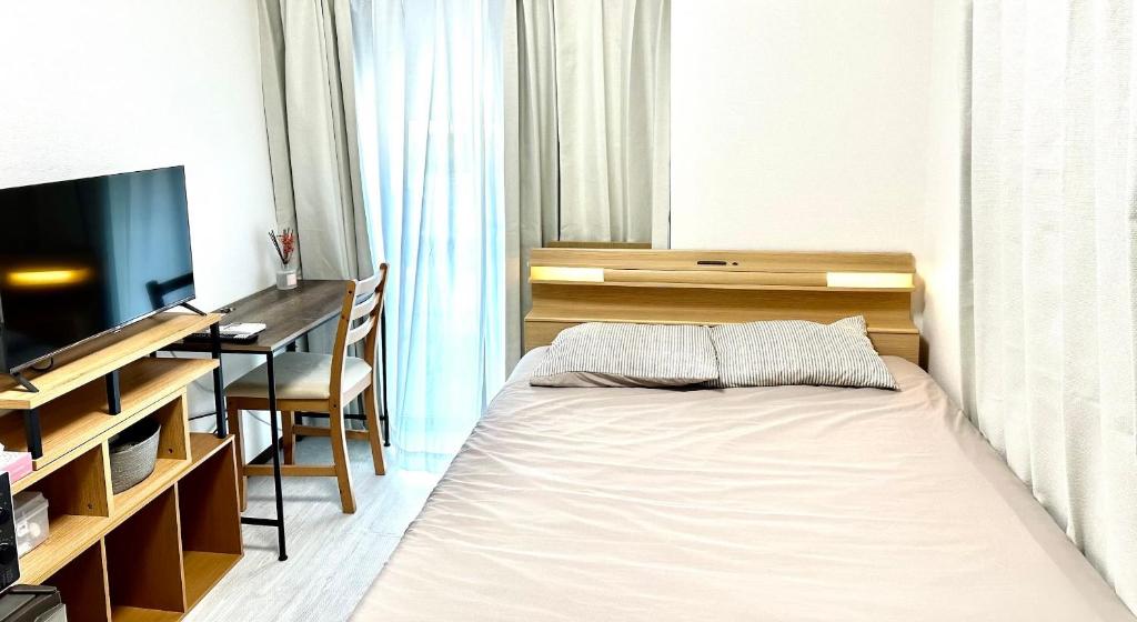 a bedroom with a bed and a desk and a television at Bon House Tokyo Private Luxury Retreat with Free Parking Reservation Required in Tokyo