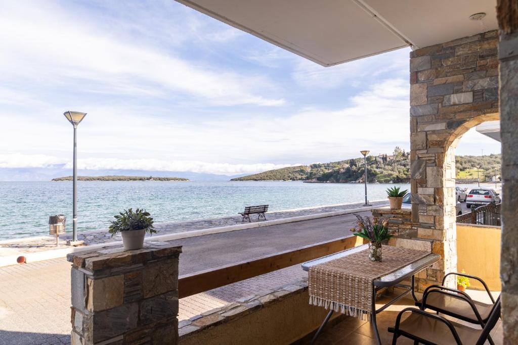 a patio with a view of the water at The litlle mermaid in Amaliapoli