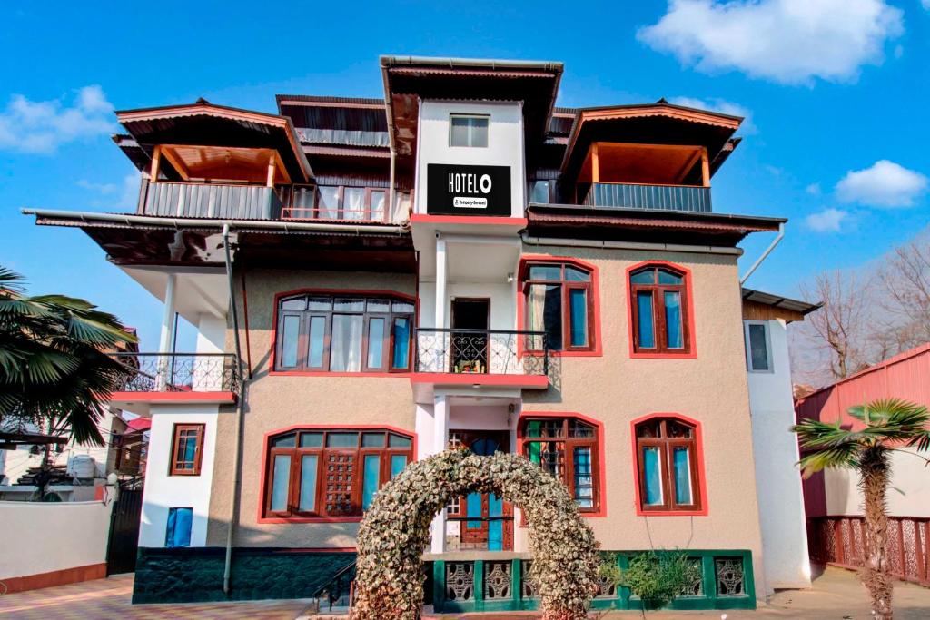 a tall building with a sign on it at Townhouse Brein Nishat in Srinagar